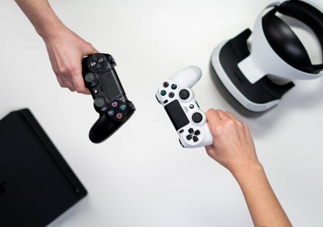 person holding white and black xbox one game controller