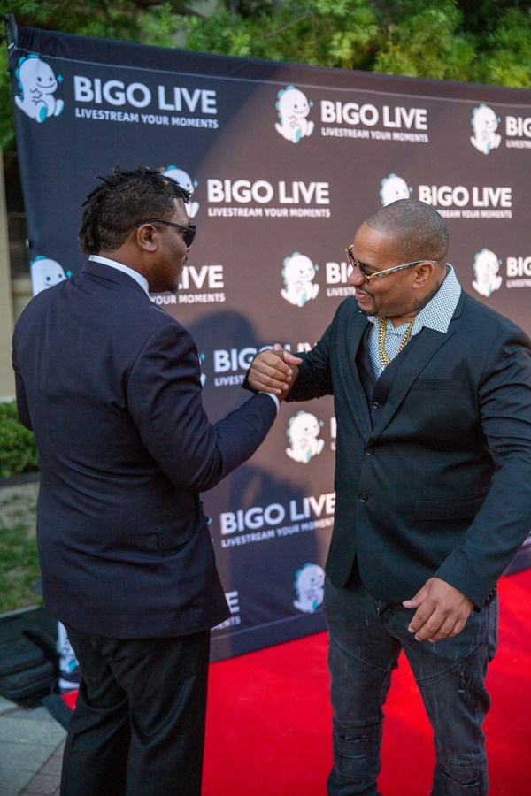 Sloan Bone greets a guest at the red carpet arrivals