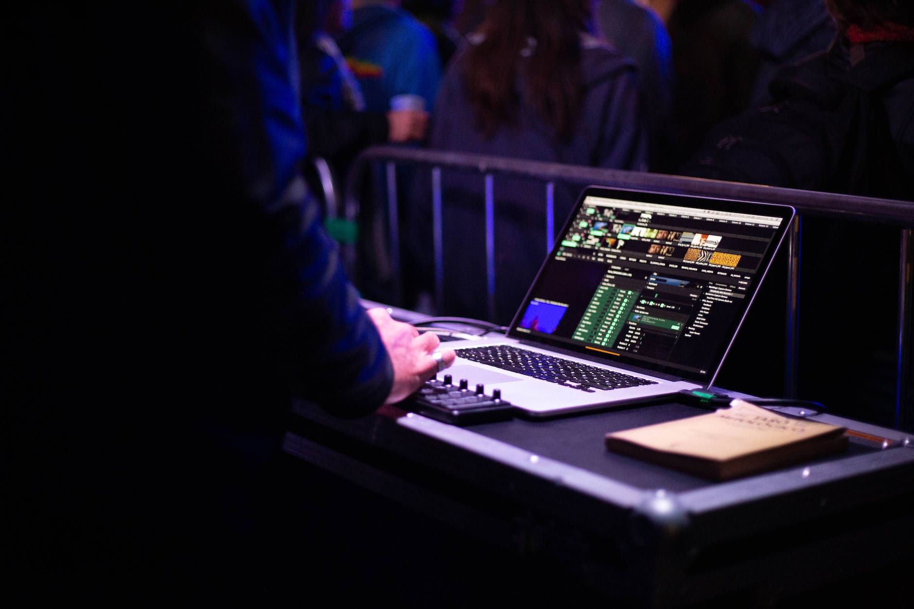 crop unrecognizable audio engineer working on console and using laptop