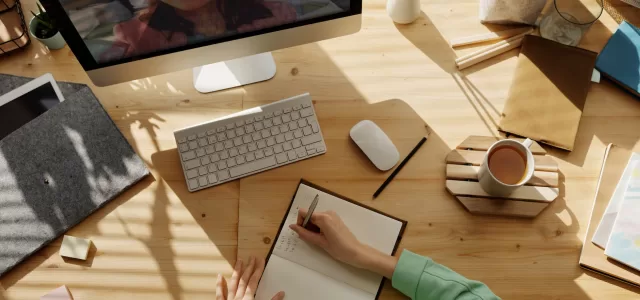 person writing on notebook