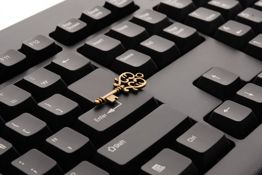 Brass Ornate Vintage Key on Black Computer Keyboard