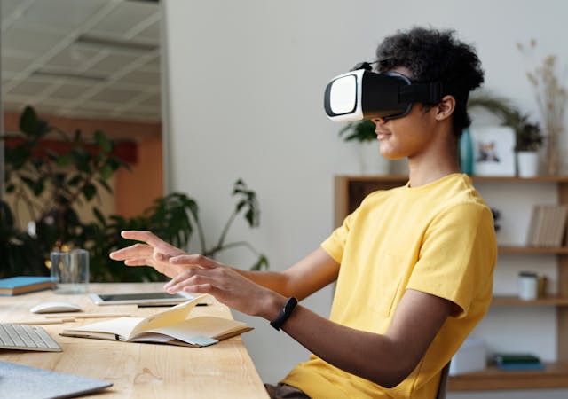 Teenager wearing a VR headset and interacting in a home setting, enjoying virtual reality experience.